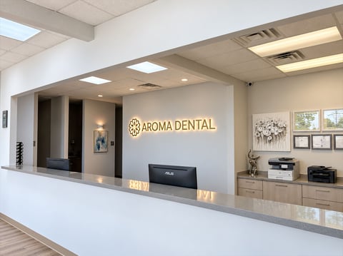 Aroma Dental reception desk with illuminated logo wall