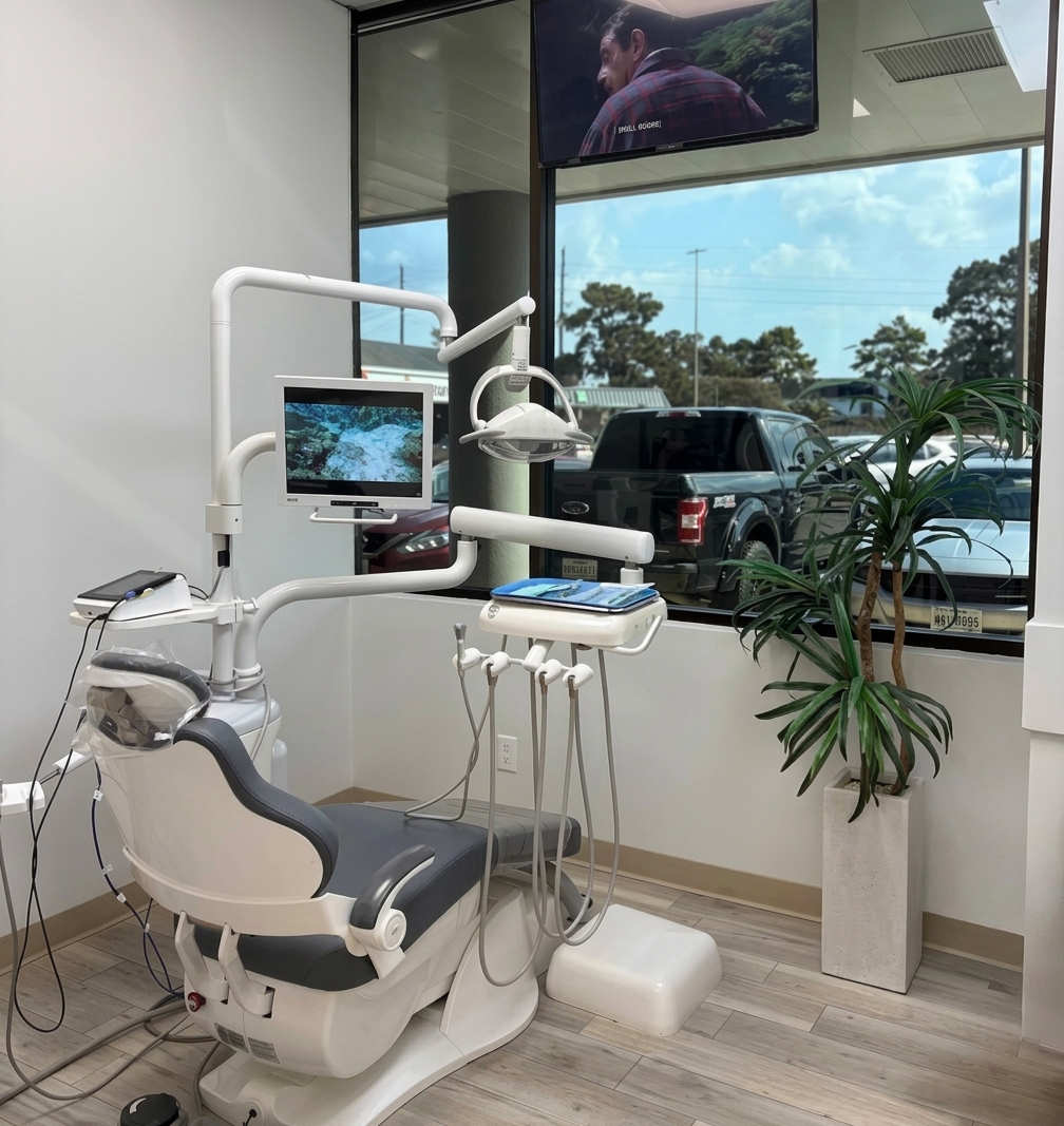 Aroma Dental treatment room with a comfortable chair and ceiling-mounted TV