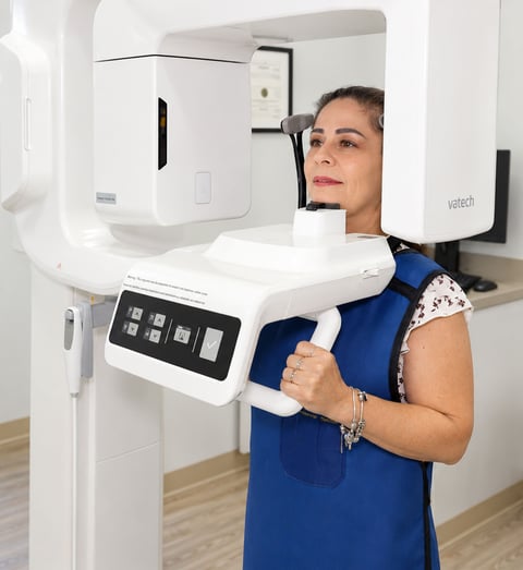 Patient having a 3D dental scan taken with the CBCT imaging machine
