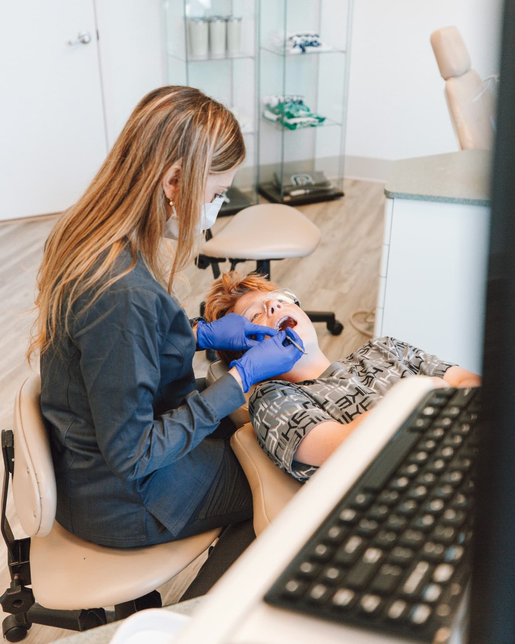 Dentist examining a patient at Aroma Dental